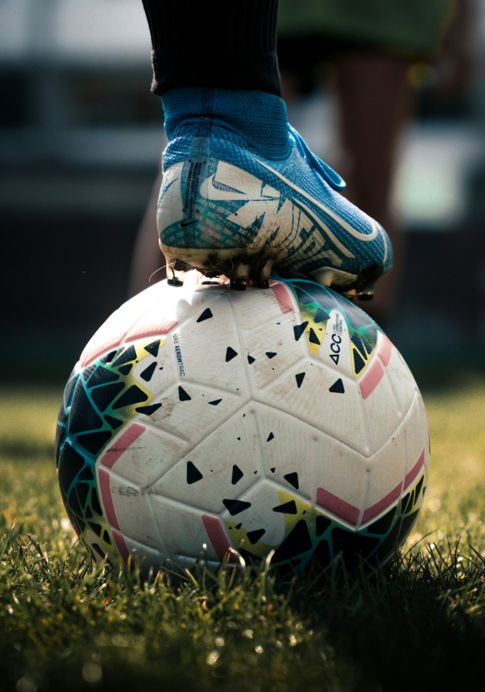 white-and-blue-soccer-ball-on-green-grass-field.jpg white and blue soccer ball on green grass field